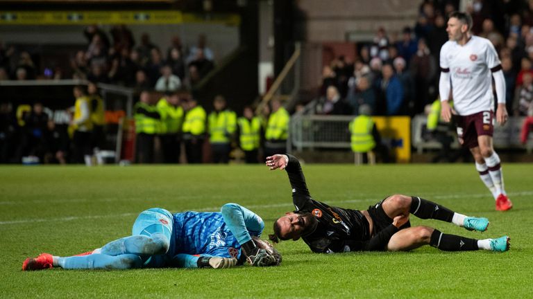 DUNDEE, SCOTLAND - DECEMBER 24: Hearts Craig Gordon and Dundee United's Steven Fletcher both go down injured after coming together during a cinch Premiership match between Dundee United and Hearts at Tannadice, on December 24, 2022, in Dundee, Scotland. (Photo by Mark Scates / SNS Group)