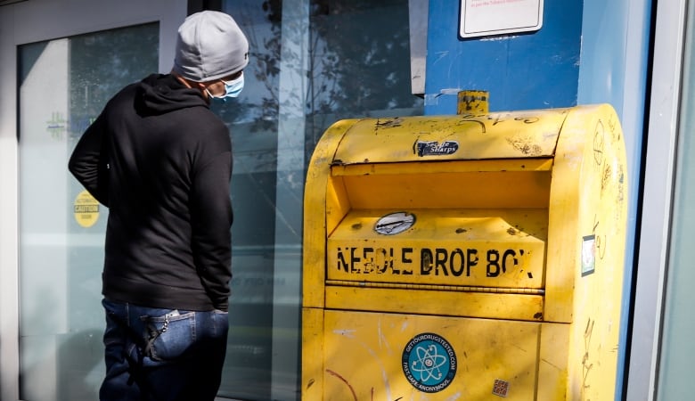 A man waits to enter a supervised consumption site.