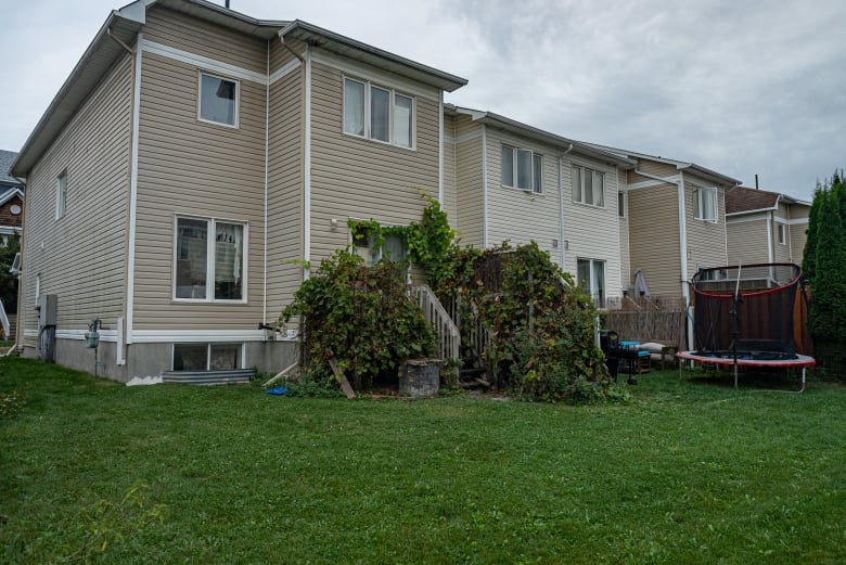 The backyard of a row house in Kanata that is infested with rats. Children toys are in the area. 