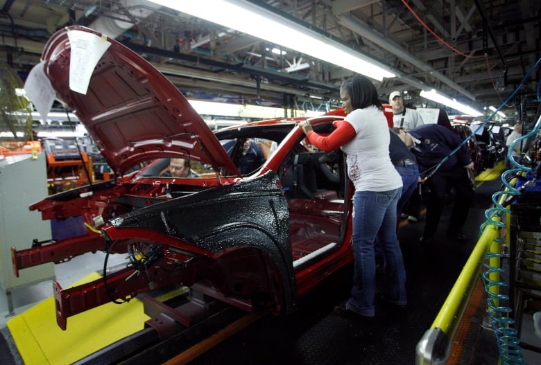 Workers assemble a pre-production vehicle at the Chrysler Belvidere Assembly plant in Belvidere, Ill., back in 2012 February 2, 2012.