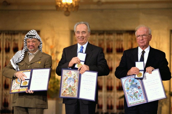 Yasser Arafat, Shimon Peres and Yitzhak Rabin display their Nobel Peace Prizes 