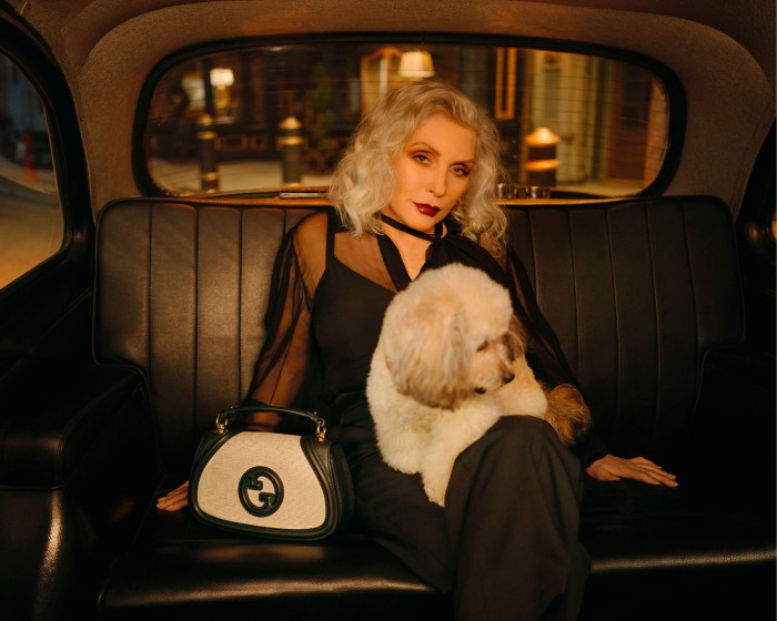 Debbie Harry in a vehicle with dog on her lap for a Gucci campaign 