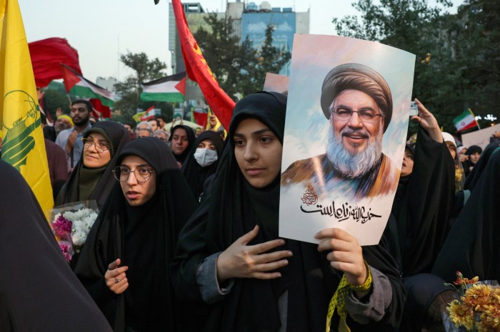 Iranians hold pictures of Hezbollah leader Hassan Nasrallah during an anti-Israel protest in Tehran