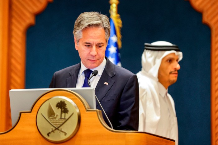 Antony Blinken stands at a podium with Sheikh Mohammed bin Abdulrahman bin Jassim al-Thani just behind him