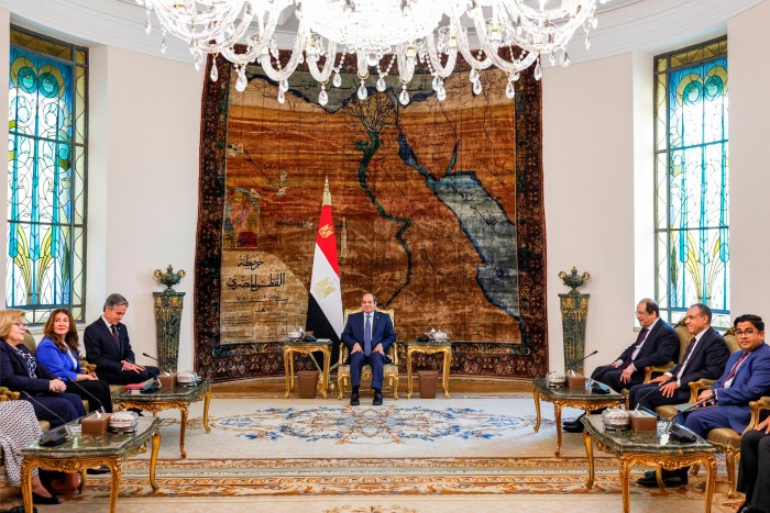 Grand stateroom with Abdel Fattah al-Sisi sitting at the head of the room with other dignitaries lining the sides of the room