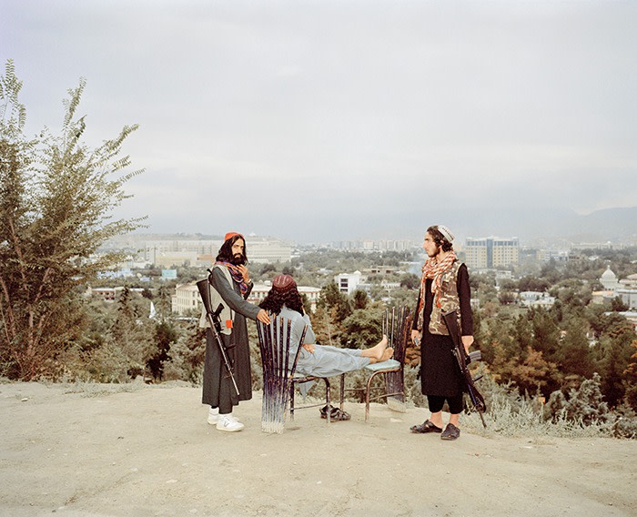 Three armed Taliban fighters overlooking Kabul