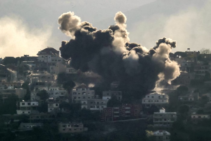 Smoke rises from the site of an Israeli air strike that targeted the southern Lebanese village of Khiam on October 9