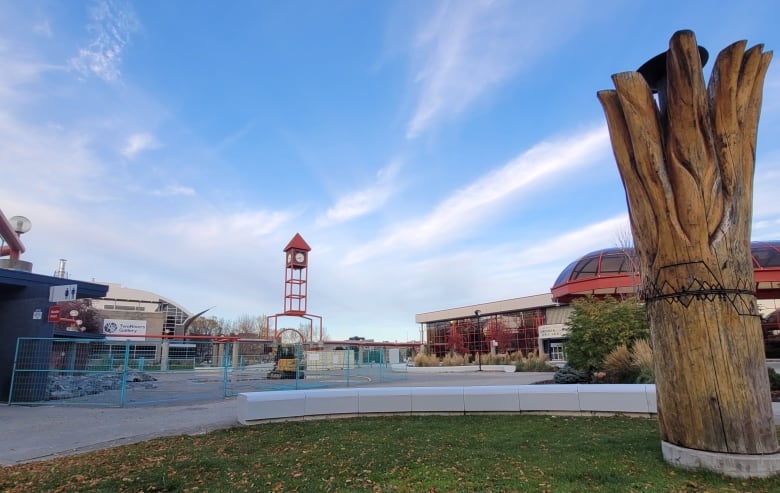 A plaza with a clocktower in the background.