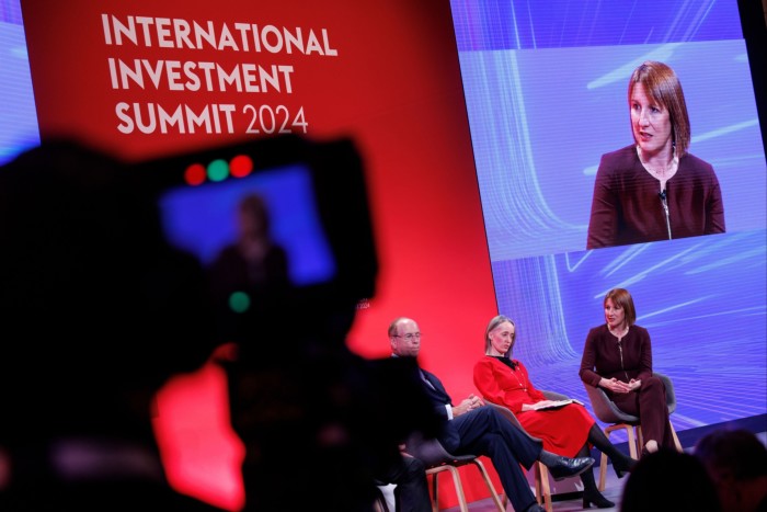 BlackRock CEO Larry Fink, left, on a panel with head of the USS pension scheme Carol Young, centre, and UK chancellor Rachel Reeves