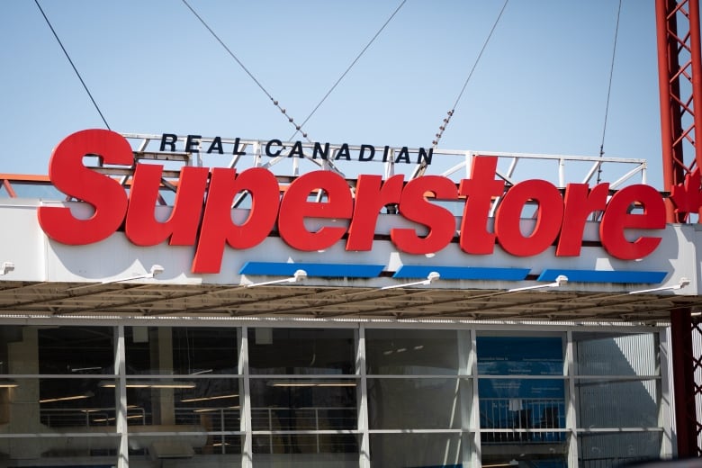 A closeup shows the exterior of a building with a sign reading "Real Canadian Superstore."