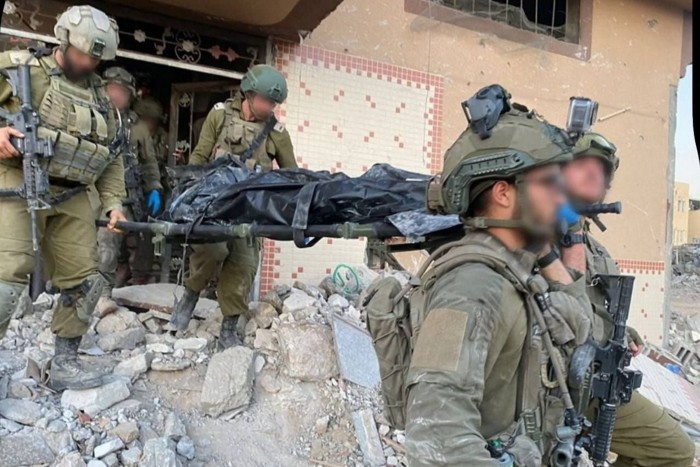 IDF soldiers carry the body of what is thought to be Hamas leader Yahya Sinwar from the building where he was killed in Rafah, Gaza on October 17, 2024