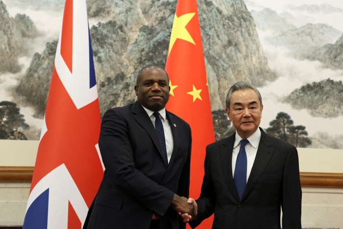 David Lammy and Chinese Foreign Minister Wang Yi shake hands in Beijing, China on October 18 2024