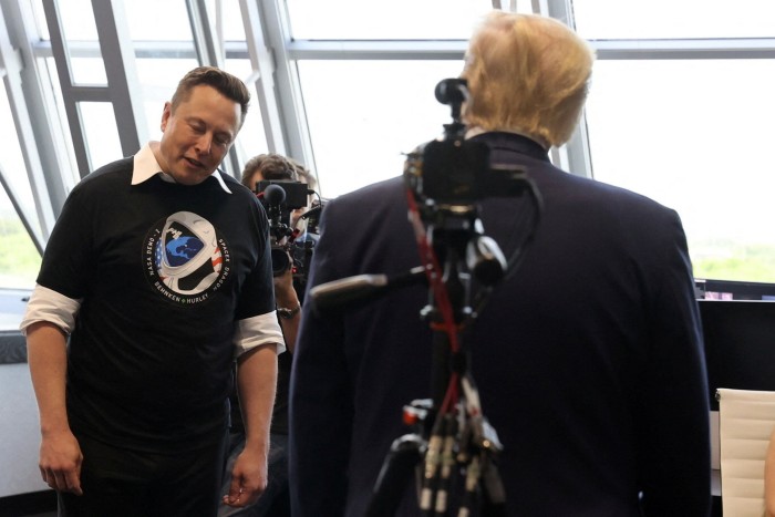 Elon Musk gives a small bow of the head as Donald Trump congratulates him after the launch of a SpaceX Falcon 9 rocket and Crew Dragon spacecraft 