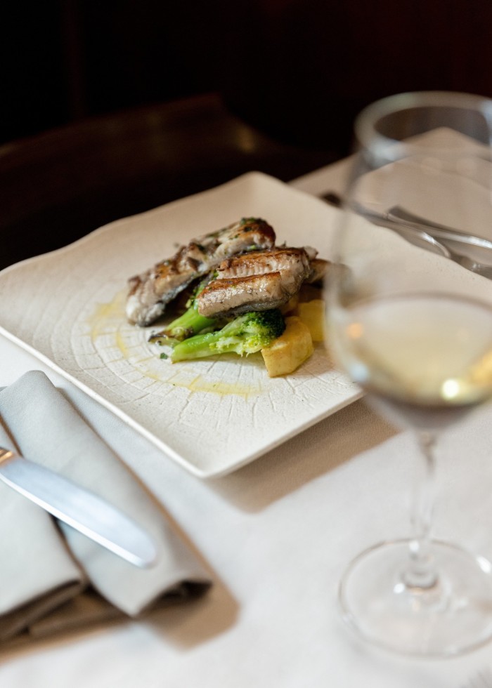 Grilled eels with vegetables on a square plate at Vini da Gigio