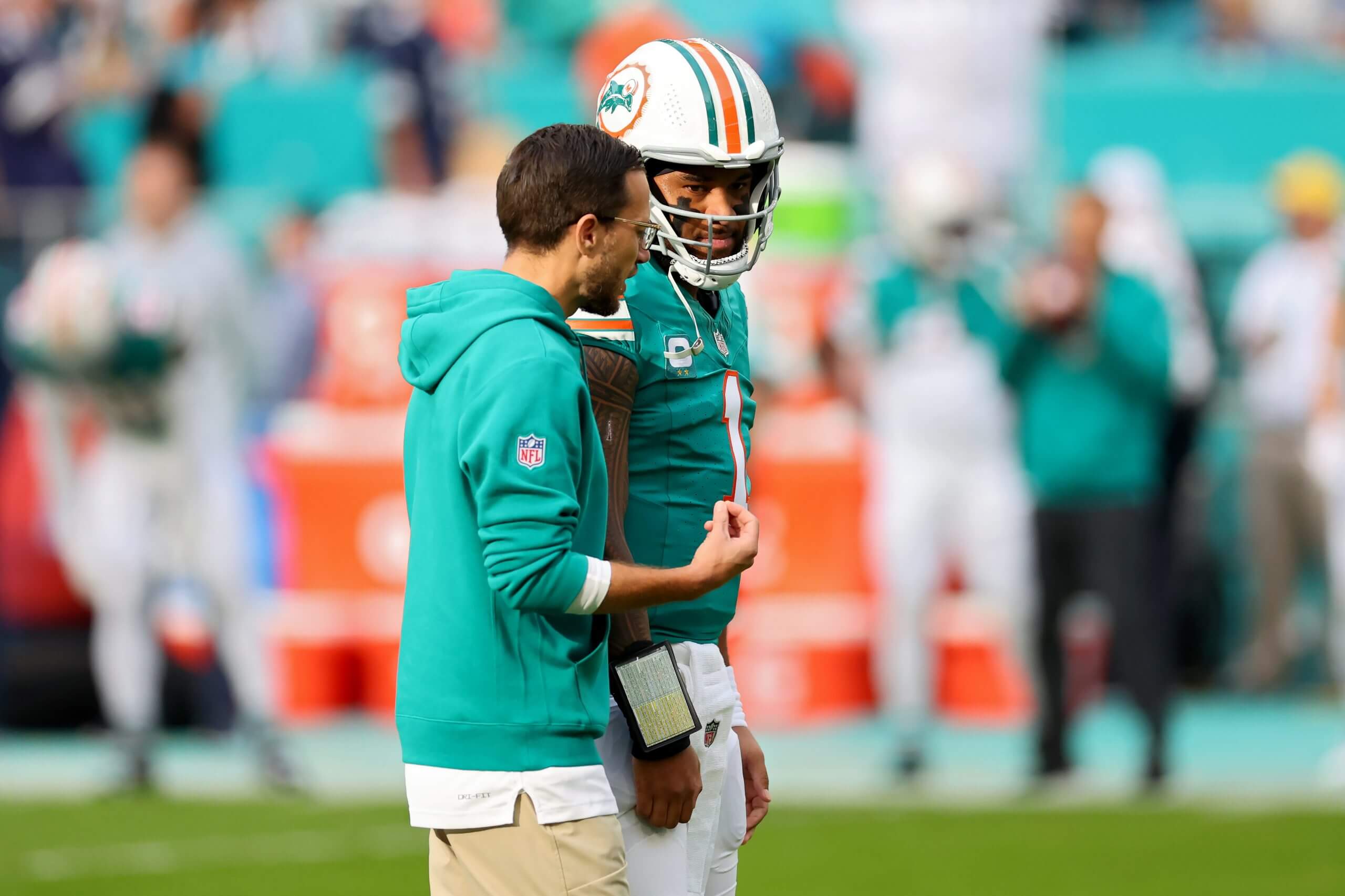 Head coach Mike McDaniel of the Miami Dolphins speaks to Tua Tagovailoa prior to the game against the Dallas Cowboys at Hard Rock Stadium on December 24, 2023 in Miami Gardens, Florida.