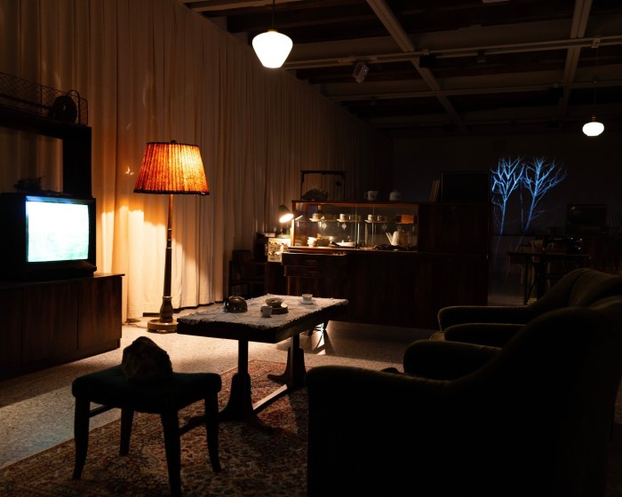 A 1960s-style living room with a television and standing lamps as part of the Bulgaria Pavilion’s ‘The Neighbours’ installation