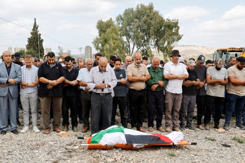 Mourners bid farewell to 60-year-old Palestinian woman, Hanan Salameh, who was shot by Israeli forces during olive harvest, according to Palestinian health ministry, in the village of Faqqua, during her funeral near Jenin, in the Israeli-occupied West Bank, October 17, 2024. 