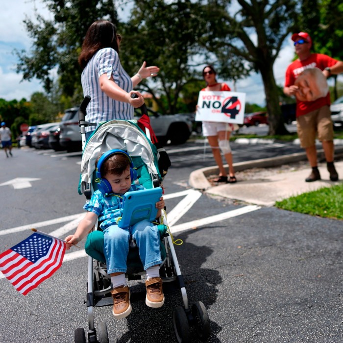 A Harris supporter, left, debates abortion rights with a pair of Trump supporters protesting alongside an event to kick off a national Reproductive Freedom Bus Tour by the Harris campaign last month in Boynton Beach