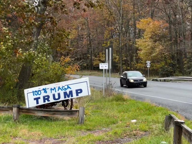 Sign off highway that says, "Trump 100% MAGA"