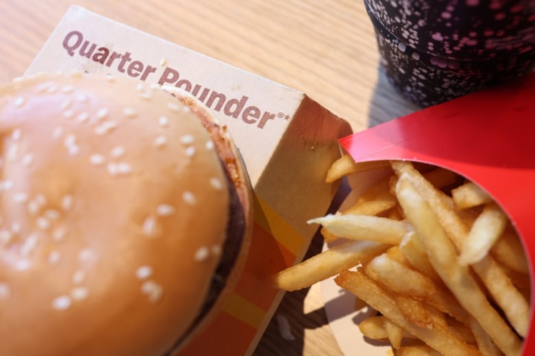 A photo illustration shows a Quarter Pounder and some related packaging as part of a hamburger meal.