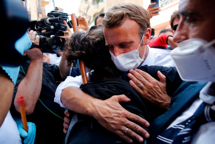 Emmanuel Macron, right, hugs a citizen during a visit to Beirut after the deadly port blast in 2020