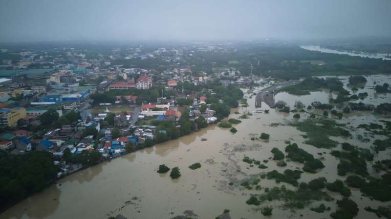 An aerial shot shows flooded houses and rice fields near a swollen river after a nearby dam was forced to release water due to heavy rains brought by Tropical Storm Trami