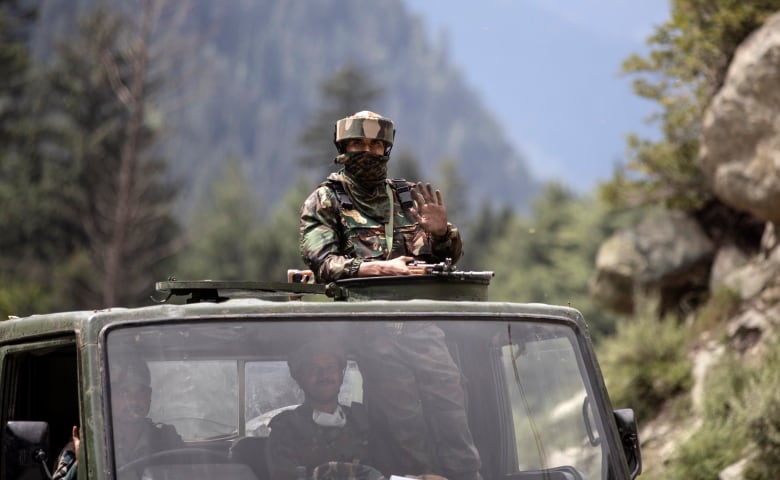 An Indian army soldier keeps guard on top of his vehicle as their convoy moves on the Srinagar- Ladakh highway at Gagangeer, northeast of Srinagar, Indian-controlled Kashmir, Tuesday, Sept. 1, 2020. India said Monday its soldiers thwarted “provocative” movements by China’s military near a disputed border in the Ladakh region months into the rival nations’ deadliest standoff in decades. China's military said it was taking “necessary actions in response," without giving details.