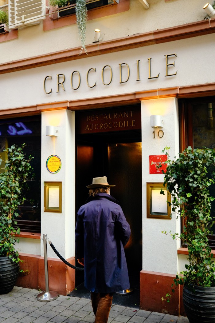 The author enters Au Crocodile, a Michelin-starred restaurant in Strasbourg