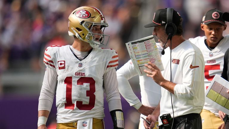 San Francisco 49ers head coach Kyle Shanahan talks with quarterback Brock Purdy (13) during the second half of an NFL football game against the Minnesota Vikings, Sunday, Sept. 15, 2024, in Minneapolis.