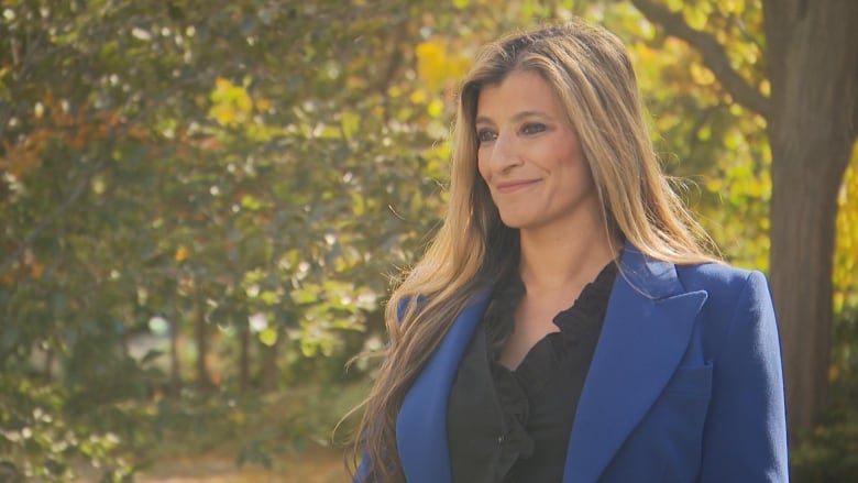 Photo of a woman in a blue blazer outside 