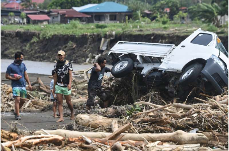 AFP reporters witnessed vehicles half-submerged in mud and homes severely damaged by flooding in Laurel