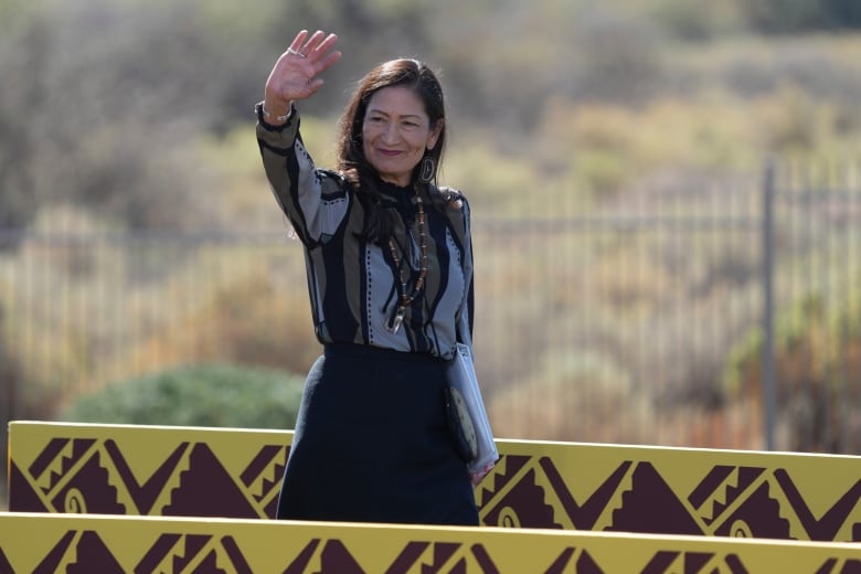 A woman waving her hand 