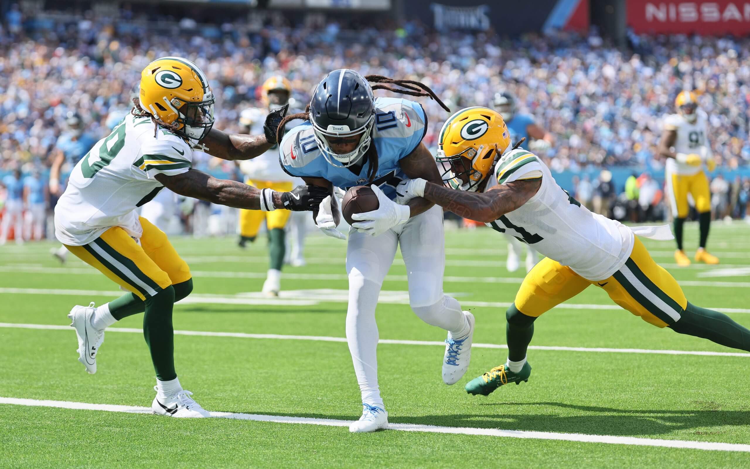 DeAndre Hopkins of the Tennessee Titans scores a touchdown against Xavier McKinney and Eric Stokes of the Green Bay Packers during the third quarter at Nissan Stadium on September 22, 2024 in Nashville, Tennessee.