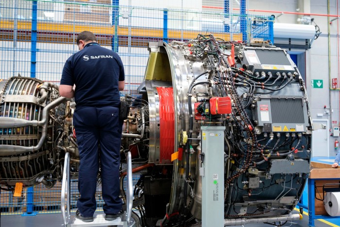 A man works on an aircraft engine in a factory in Belgium