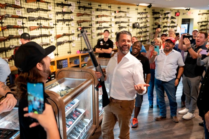 Donald Trump Jr., son of former US President and Republican presidential candidate Donald Trump, holds a shotgun at Tombstone Tactical gun store  in Phoenix, Arizona