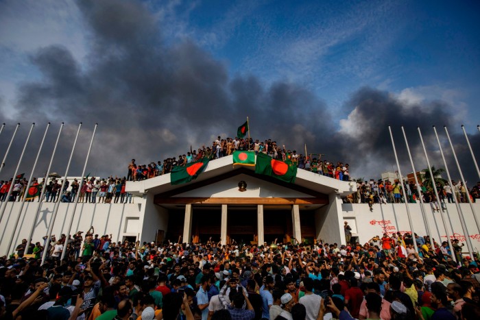 Protesters crowd onto the residence’s walls and roof