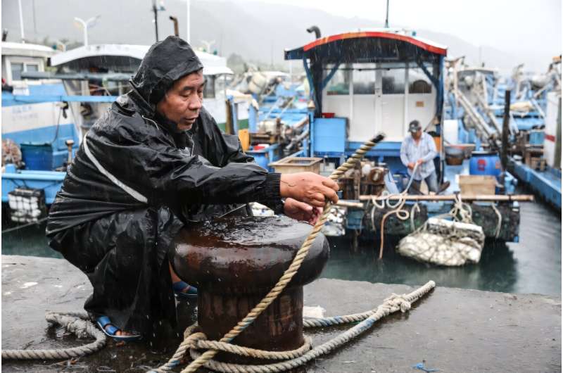 A fisherman secures a boat as Typhoon Kong-rey approaches Taiwan's Yilan County on Wednesday