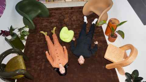 Monling Lee (left) and Justin Donnelly in the Jumbo studio in New York City. At their feet are Fortune chairs, $1,175 each, hellerfurniture.com. In the centre is a scale model of the Sport sofa