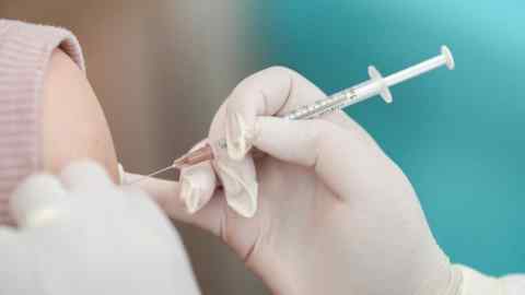 A close up shot of a Covid vaccine being administered