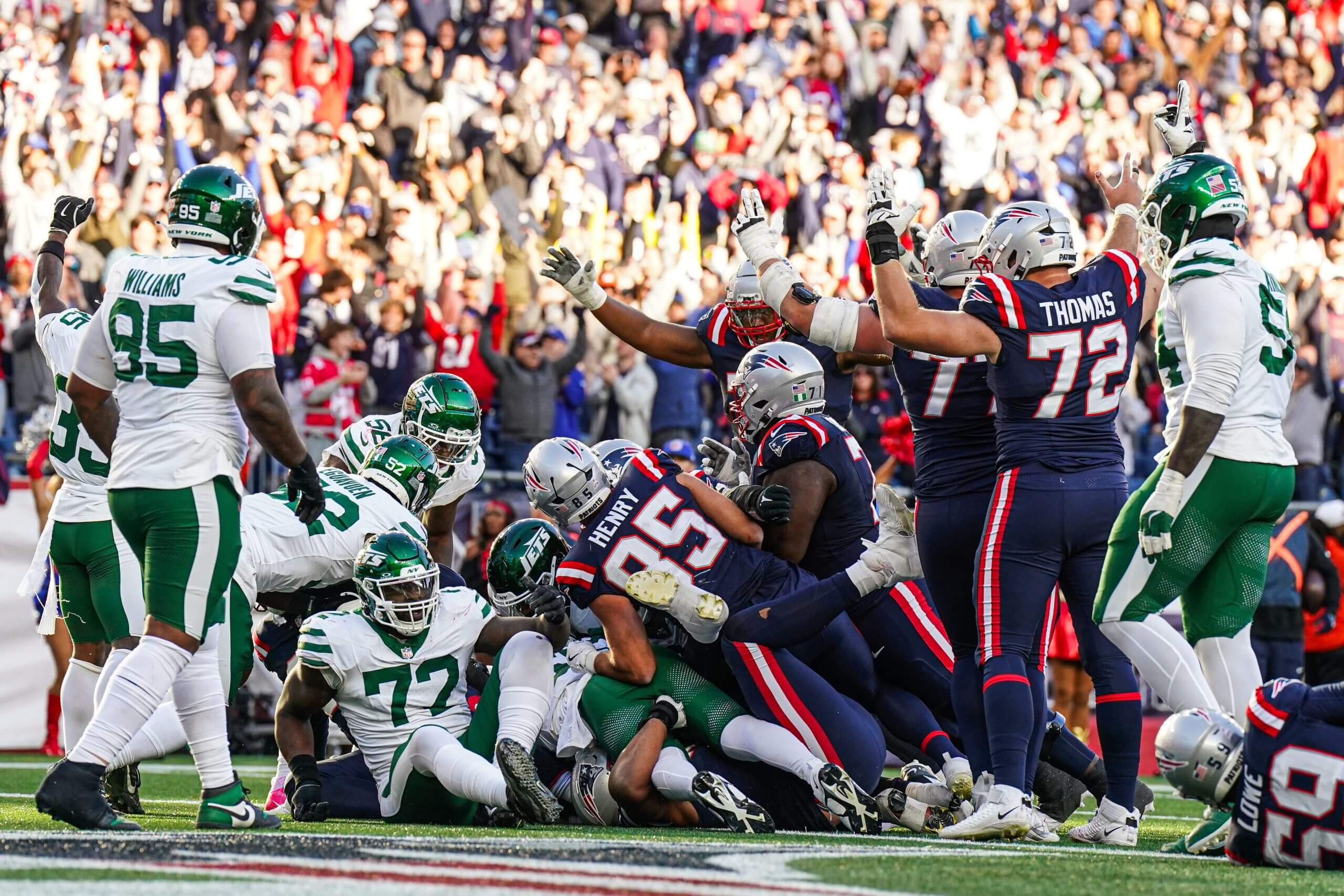 The New England Patriots react after a touchdown by running back Rhamondre Stevenson against the New York Jets in the second half at Gillette Stadium.