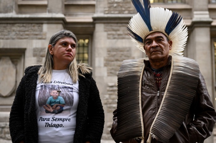 Cacique Bayara and Gelvana Rodrigues stand outside the High Court in London