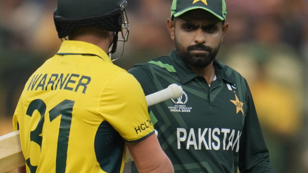 Pakistan's captain Babar Azam congratulates Australia's David Warner on his fine innings after Warner got out during the ICC Men's Cricket World Cup match between Australia and Pakistan in Bengaluru, India, Friday, Oct. 20, 2023. (AP Photo/Aijaz Rahi)