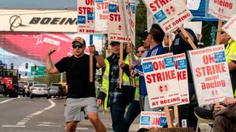 Boeing workers picket outside of the Boeing Everett factory during an ongoing strike in Everett, Washington