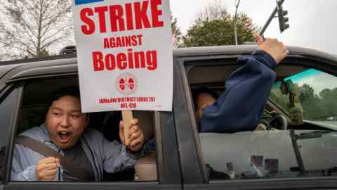 Workers picket outside a Boeing facility in Everett, Washington