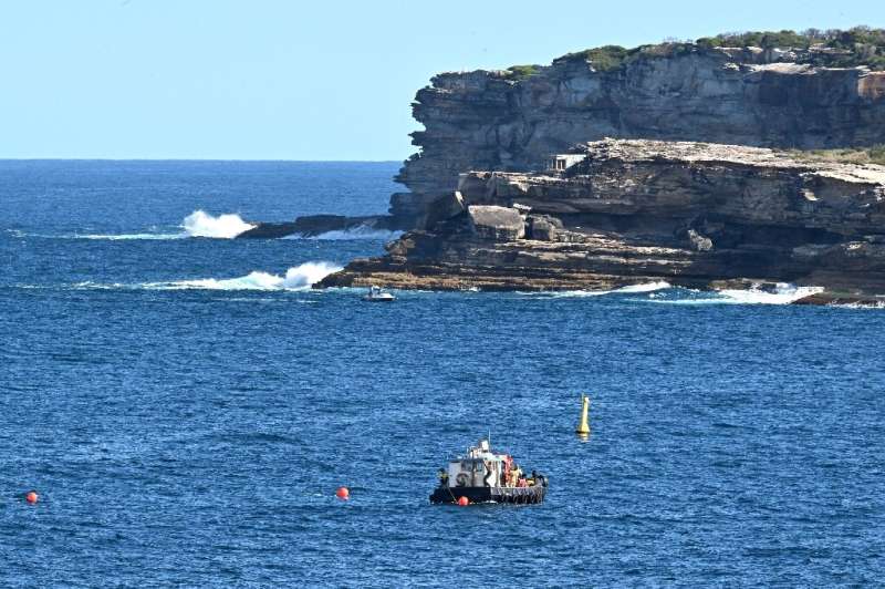 A boat patrols the waters of Maroubra Beach after authorities closed down two adjacent beaches in Sydney due to mysterious 'tar balls' washing ashore