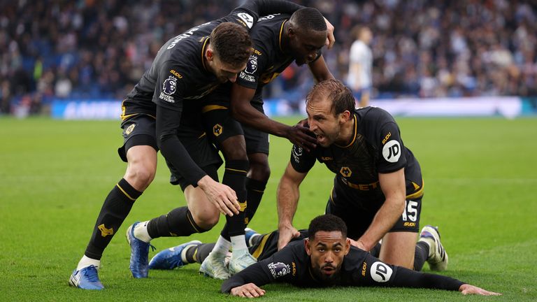 Matheus Cunha is bundled on by his Wolves teammates after scoring. 