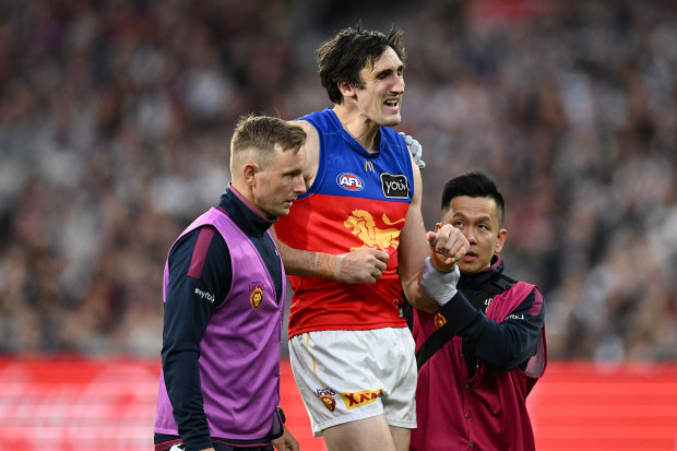 Oscar McInerney of the Lions is helped by the team physio.