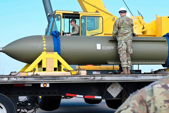 Servicemen look at a GBU-57, or the Massive Ordnance Penetrator bomb, at Whiteman Air Base in Missouri