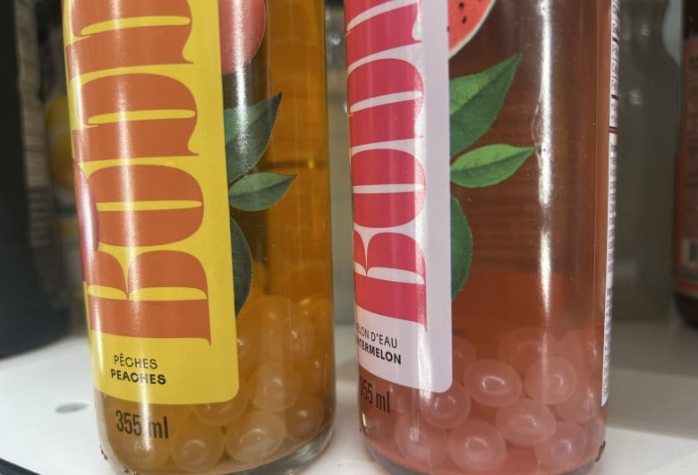 Two bottles of a bubble tea beverage are shown on a supermarket shelf.