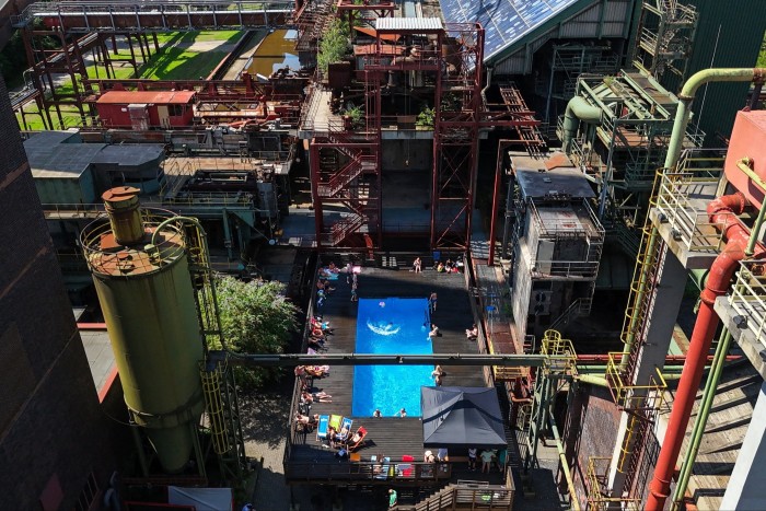 An aerial view shows people swimming in the ‘Werksschwimmbad’ swimming pool at Zeche Zollverein